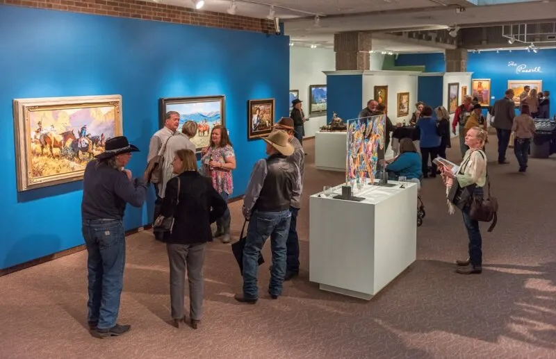 Art tourists standing inside CM Russel Museum