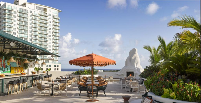 Patio with tables and chairs outside the Coconut Grove Hotel
