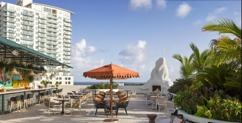 Patio with tables and chairs outside the Coconut Grove Hotel