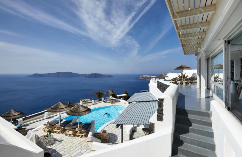 An Outdoor Pool and Skyline View of Santorini Princess Spa Hotel